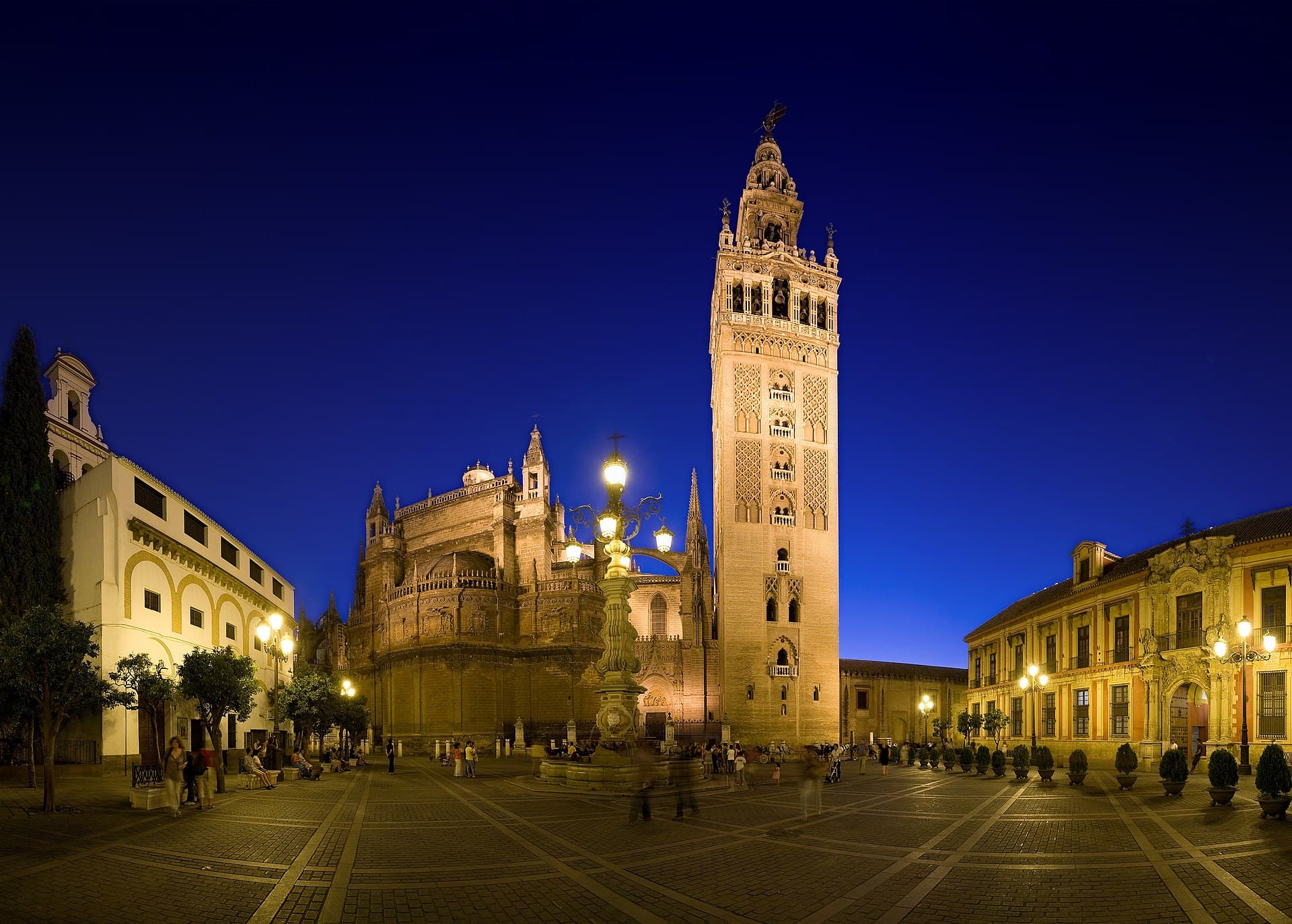 An ultrawide angle view of the Plaza Virgen de los Reyes looking west towards the Cathedral of Seville and the Giralda. On the left is the Convento de la Encarnacion and on the right is the Palacio Arzobispal (the Archbishop's Palace). This is a 4 segment panorama taken with a Canon 5D and 17-40mm f