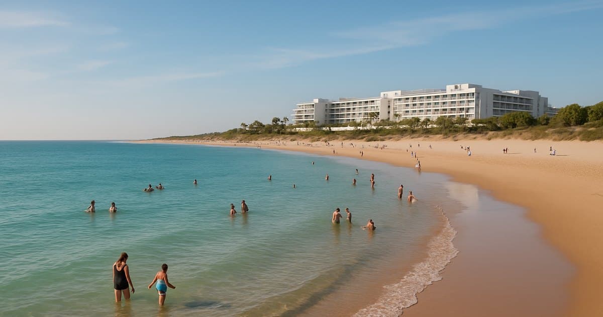 Playa La Barrosa con arena blanca, agua turquesa y bañistas disfrutando.